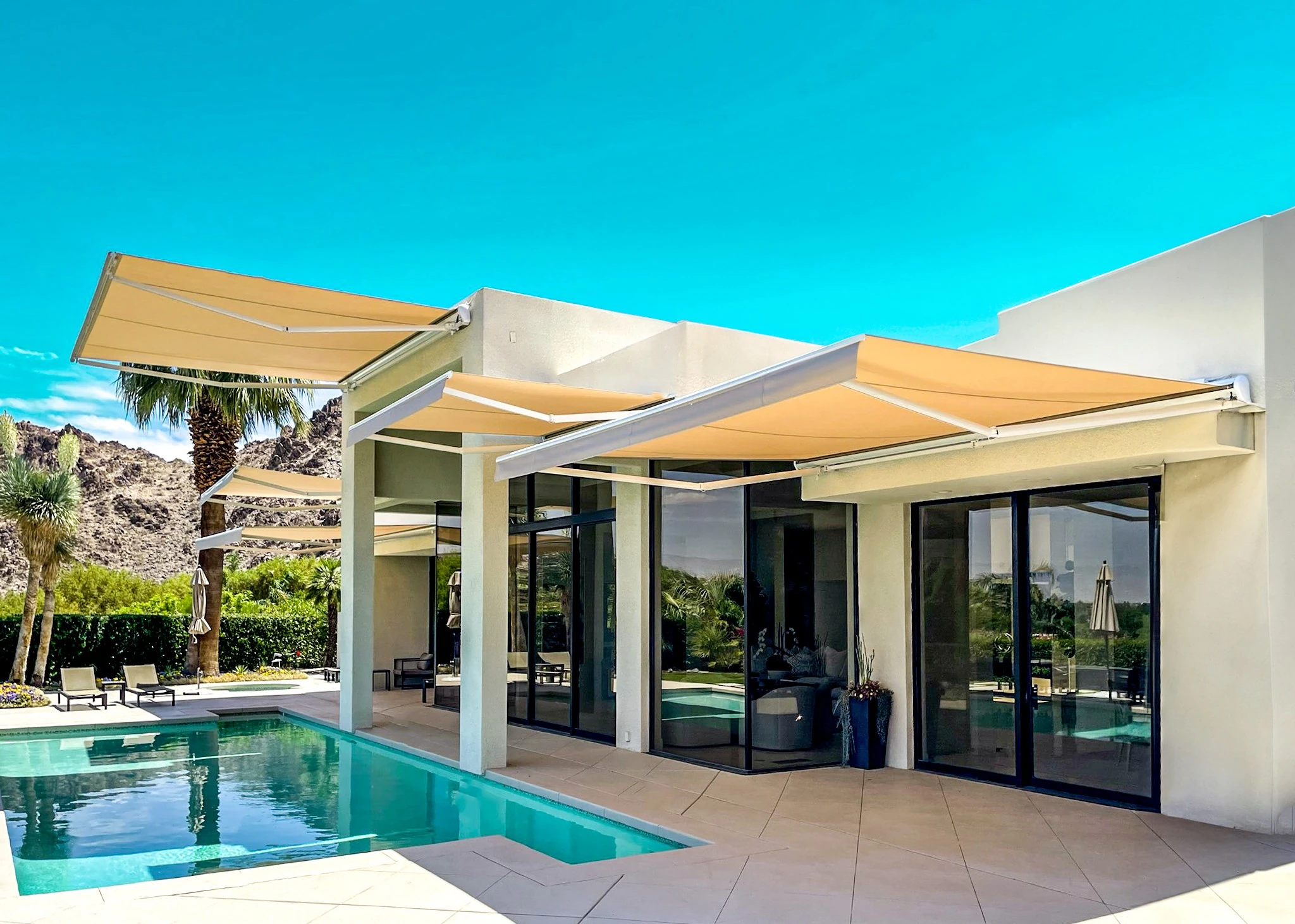 Motorized retractable awning extended over a patio